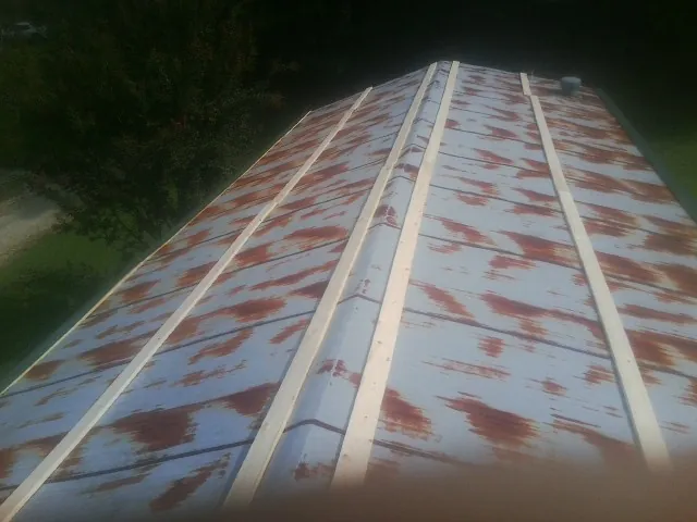 Rusted metal roof panels with new wood purlins before replacement — Storm Damage Roof Repair in Pennock by Roofing Brothers